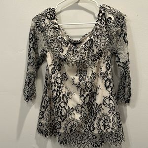 White House Black Market. Black and off white lace blouse. Size XS. Fits Sz S.